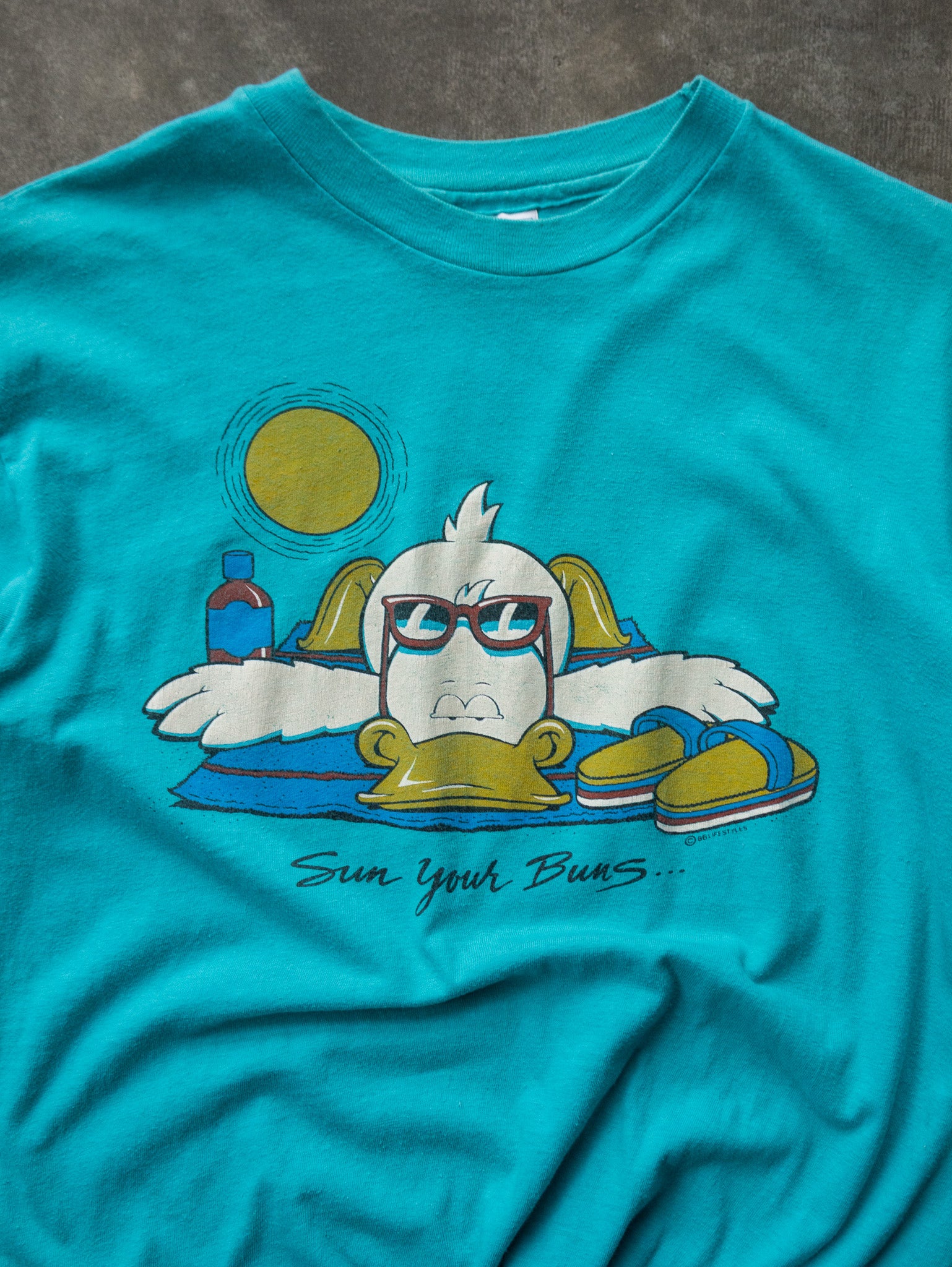 Vintage 1985 Turquoise Sun Your Buns Graphic Tee (M)
