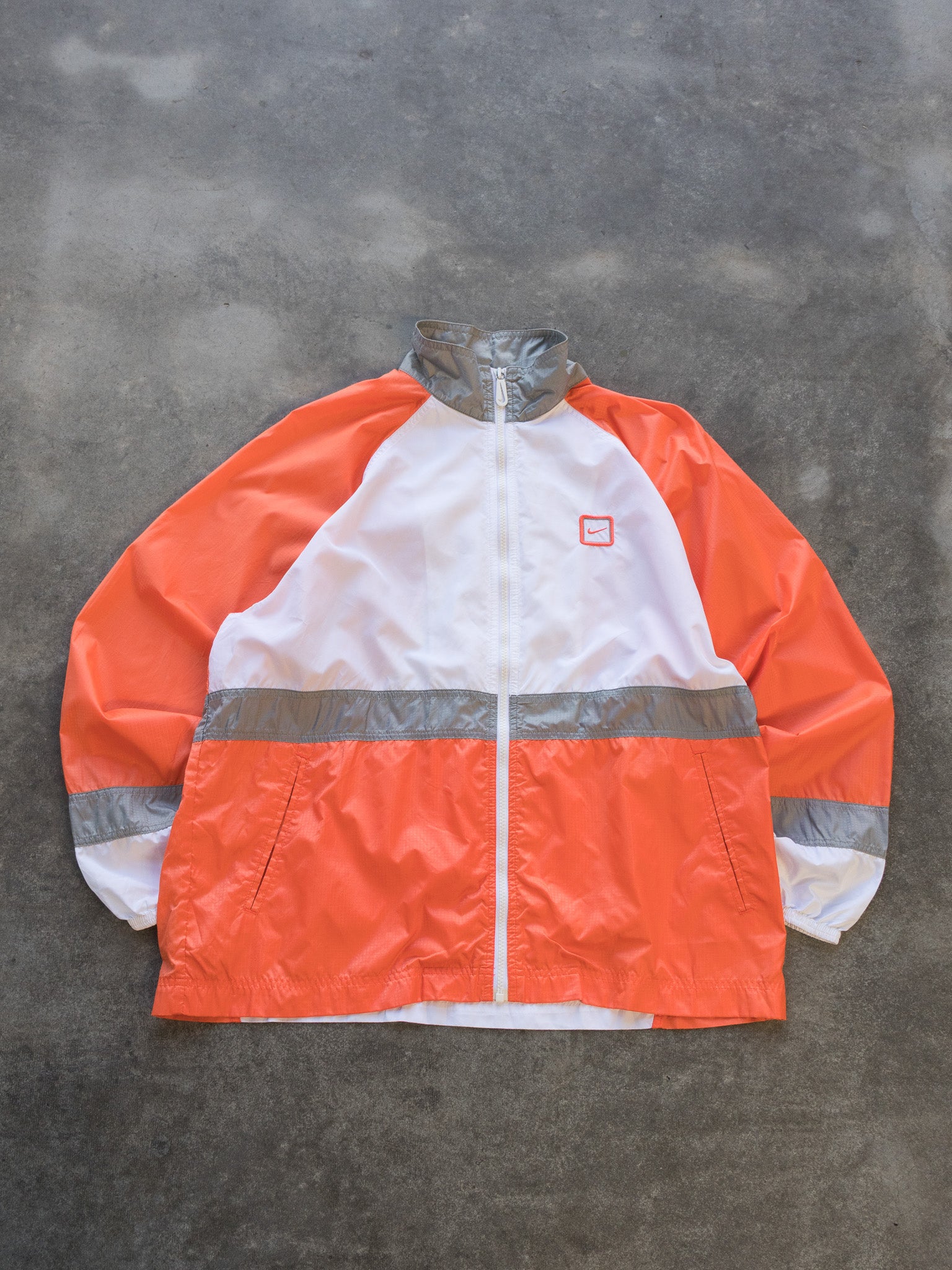 white and orange nike windbreaker